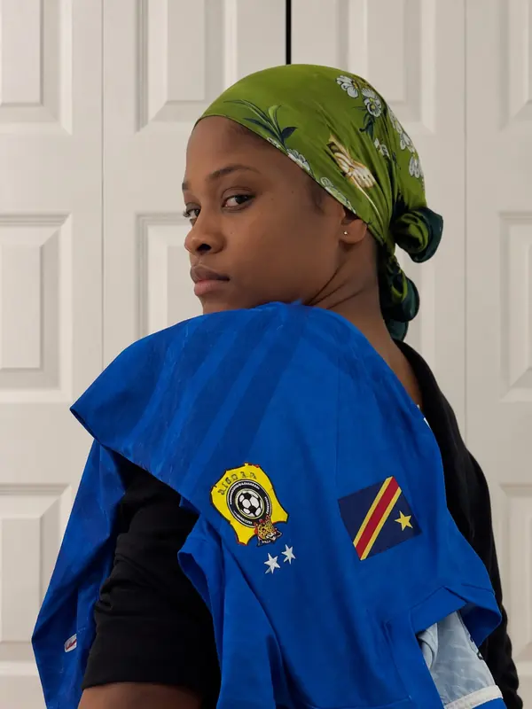 Casting archive — model with a cobalt jersey draped over the shoulder